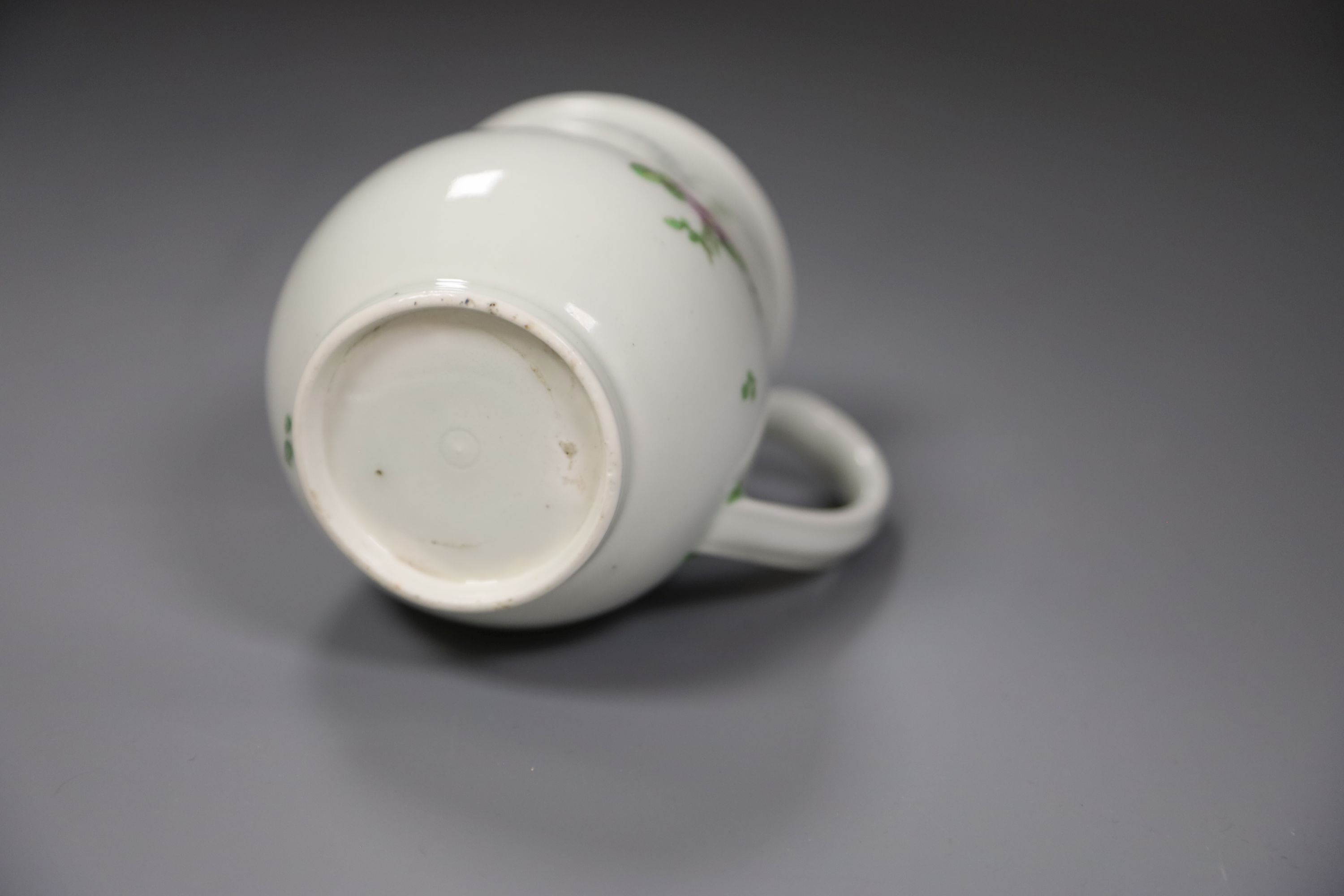 A Worcester bell shape mug painted with scattered coloured flowers, height 9cm